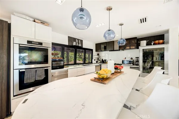 a view of a kitchen with dining area windows and chairs