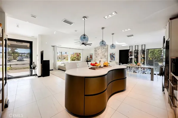 a kitchen and a dining table with appliances
