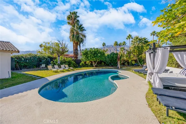 a view of a swimming pool with a yard