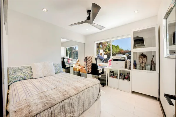 a bedroom with a bed chair and window