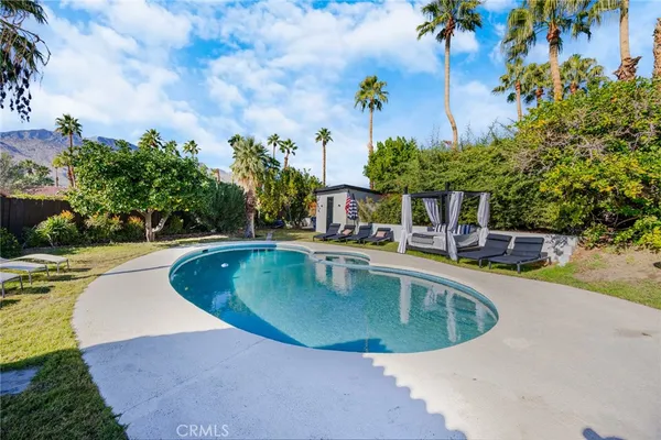 a view of a swimming pool with a yard