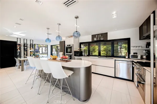 a kitchen with stainless steel appliances kitchen island granite countertop a sink and cabinets