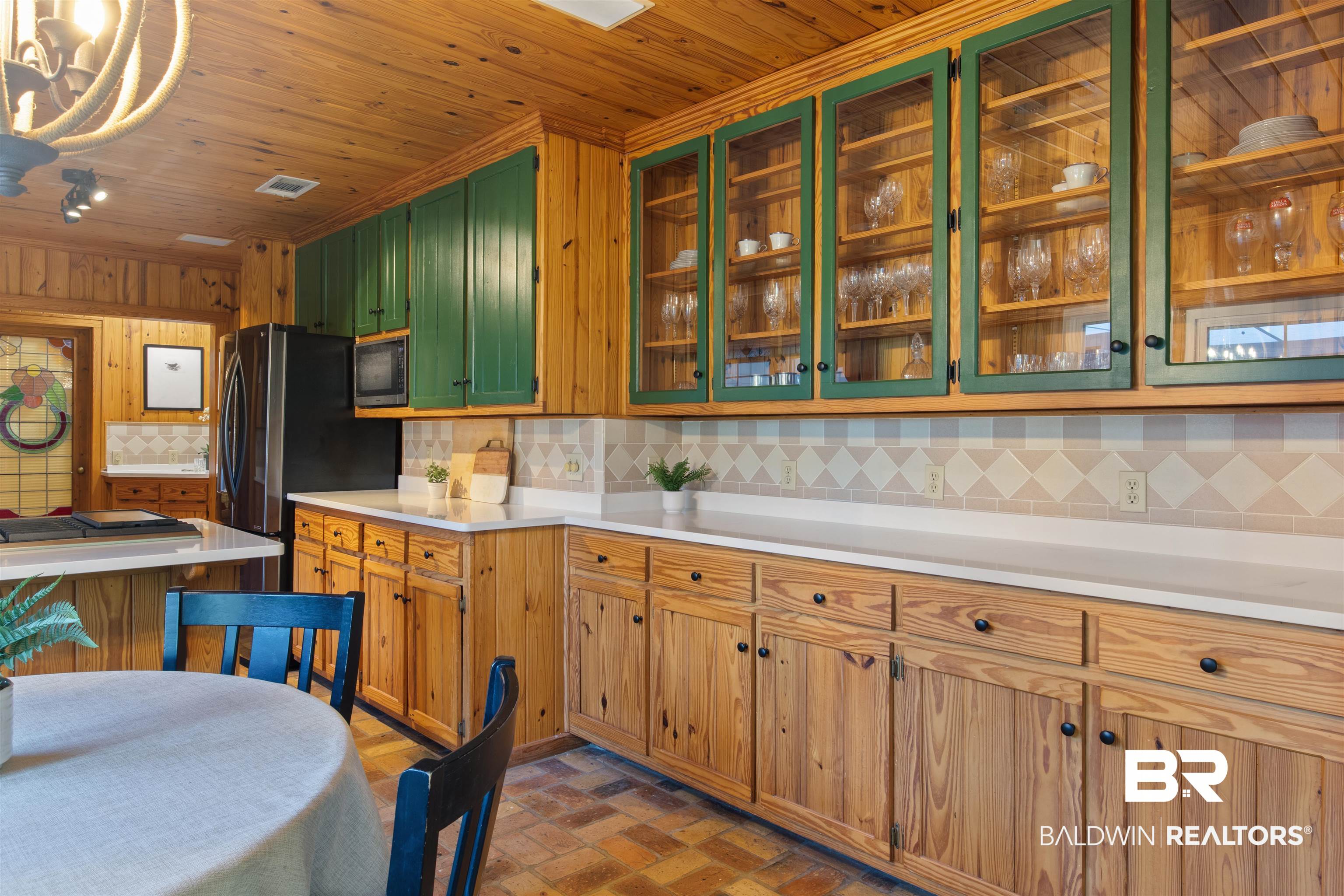 15100 Vasko Road Silverhill, AL 36576 - Photo 13 of 51 Kitchen with wood ceiling, a chandelier, and decorative backsplash. Breakfast area with custom made display cabinetry flows nicely into dining room and front entry room.