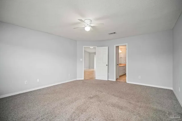 a view of an empty room with a ceiling fan
