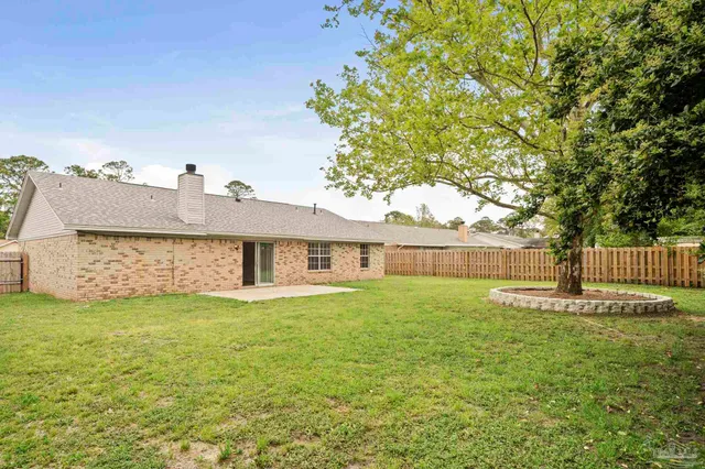 a view of backyard with large trees