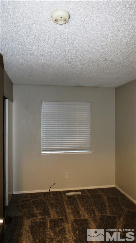 2015 Trainer Way Reno, NV 89512 - Photo 20 of 22 an empty room with wooden floor and windows