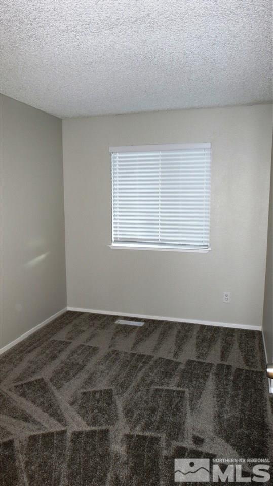 2015 Trainer Way Reno, NV 89512 - Photo 21 of 22 an empty room with wooden floor and windows