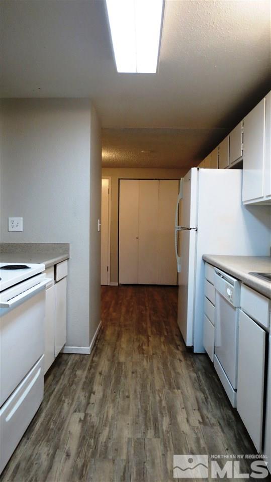 2015 Trainer Way Reno, NV 89512 - Photo 6 of 22 a kitchen with a refrigerator and white cabinets