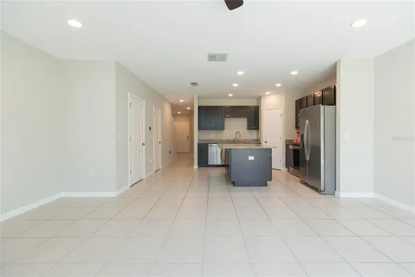 a large kitchen with a large counter top stainless steel appliances and cabinets