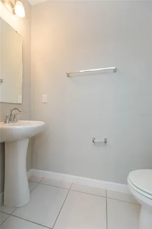 a bathroom with a sink toilet and a mirror