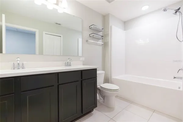 a bathroom with a sink a toilet a shower and a mirror