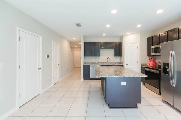 a large kitchen with stainless steel appliances lots of counter top space and cabinets