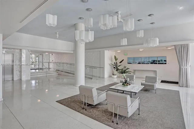 a living room with fireplace furniture and a view of kitchen