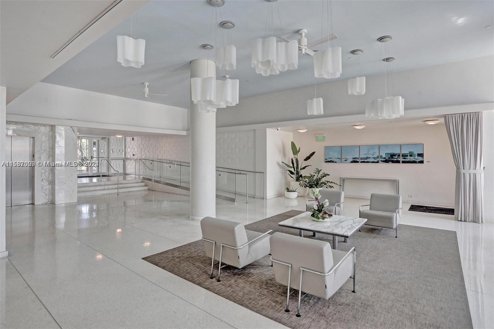 3 Island Avenue, Unit 10K Miami Beach, FL 33139 - Photo 13 of 19 a living room with fireplace furniture and a view of kitchen