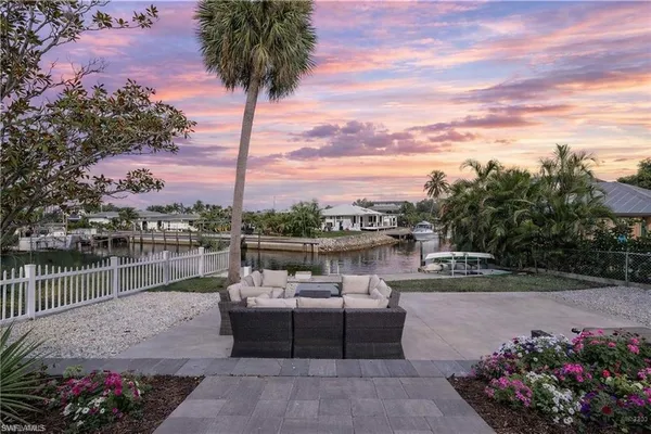 a balcony with outdoor seating and plants