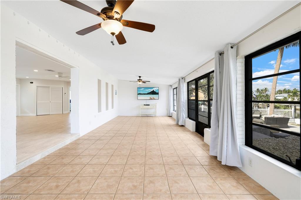 3461 Lakeview Drive Naples, FL 34112 - Photo 18 of 32 a large space with chandelier fan and windows