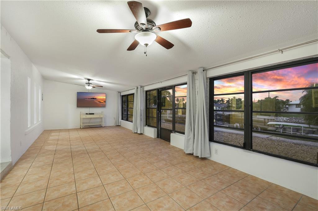 3461 Lakeview Drive Naples, FL 34112 - Photo 19 of 32 a view of empty room with wooden floor and fan