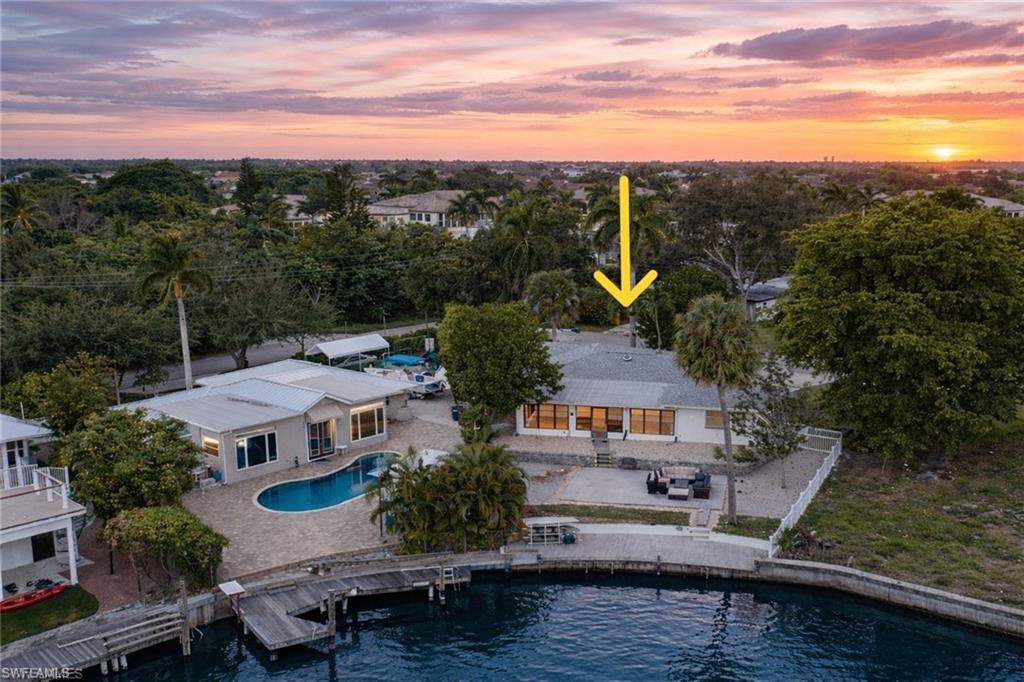 3461 Lakeview Drive Naples, FL 34112 - Photo 2 of 32 a view of houses with a lake
