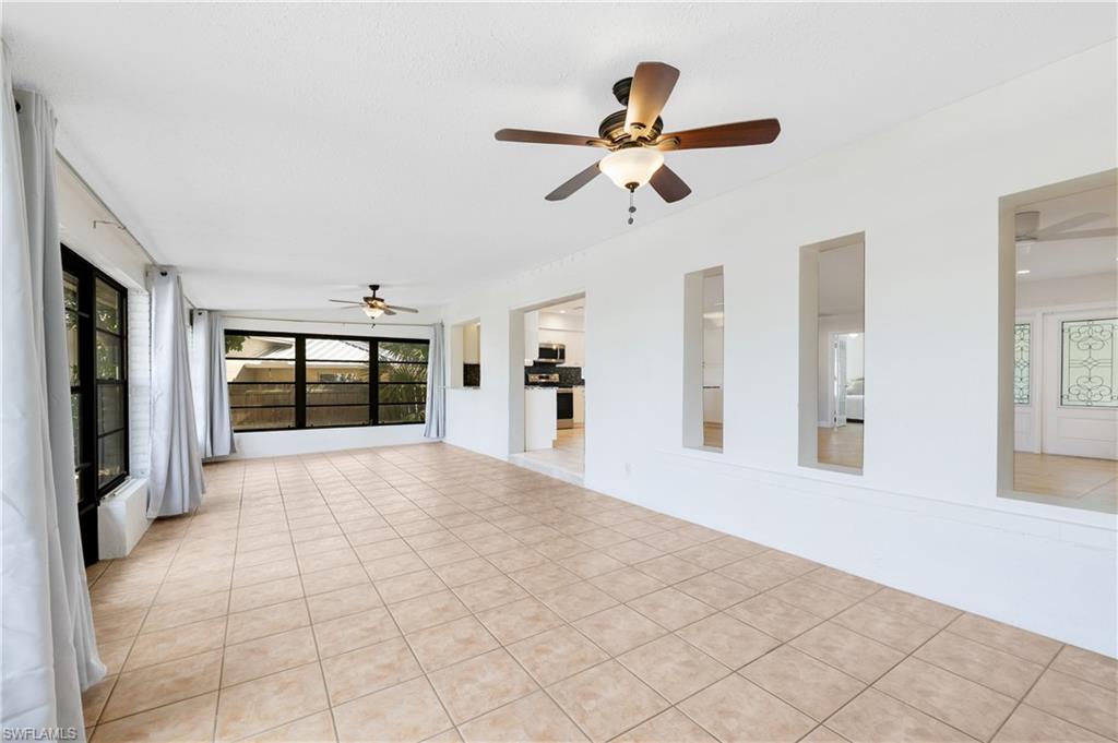 3461 Lakeview Drive Naples, FL 34112 - Photo 22 of 32 a view of a livingroom with a ceiling fan and window