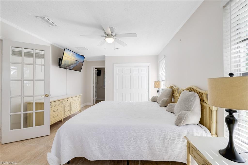 3461 Lakeview Drive Naples, FL 34112 - Photo 23 of 32 a bedroom with a bed and wooden floor