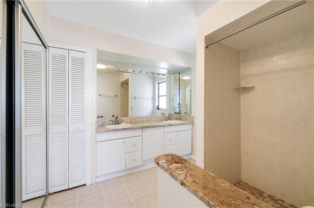 3461 Lakeview Drive Naples, FL 34112 - Photo 25 of 32 a bathroom with a granite countertop sink and a mirror