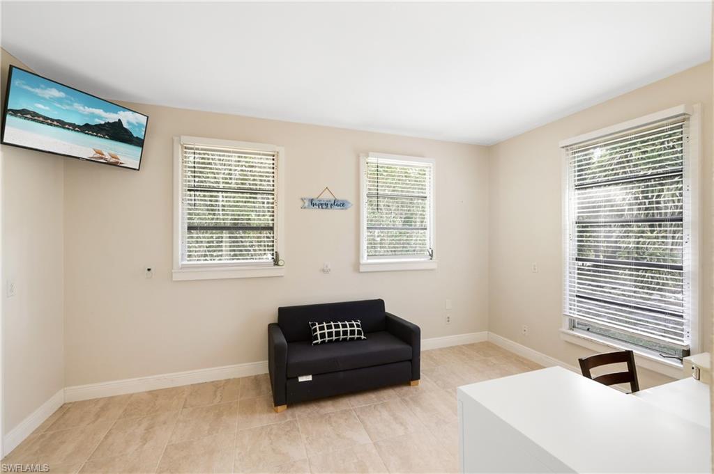 3461 Lakeview Drive Naples, FL 34112 - Photo 26 of 32 a spacious bedroom with a bed and a window