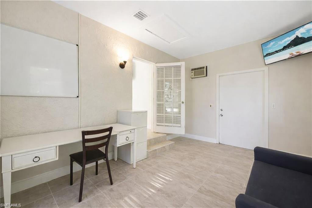 3461 Lakeview Drive Naples, FL 34112 - Photo 28 of 32 a view of a workspace with furniture and a window