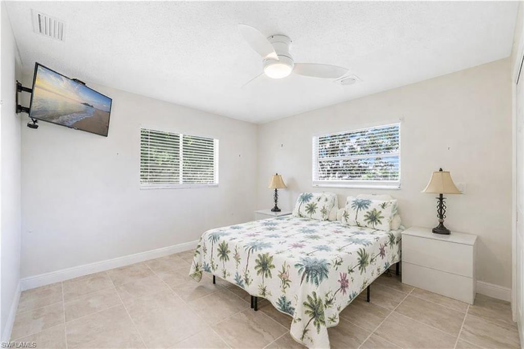 3461 Lakeview Drive Naples, FL 34112 - Photo 29 of 32 a bedroom with a bed and a window