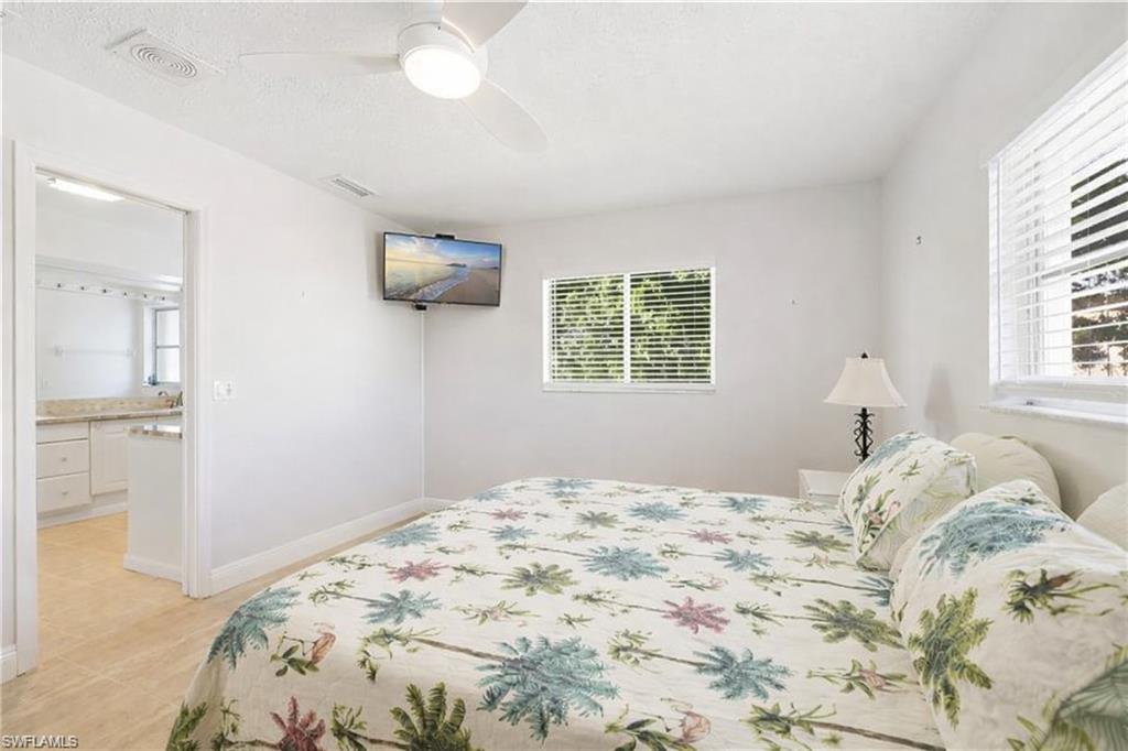3461 Lakeview Drive Naples, FL 34112 - Photo 30 of 32 a bedroom with a bed and a window