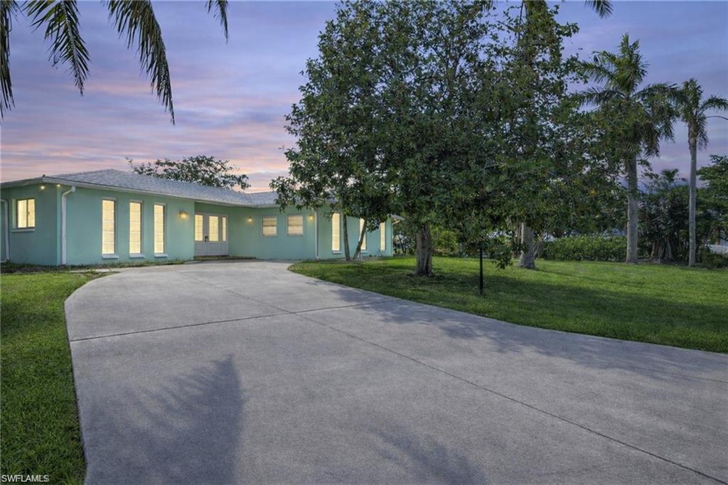 3461 Lakeview Drive Naples, FL 34112 - Photo 3 of 32 a house view with a garden space