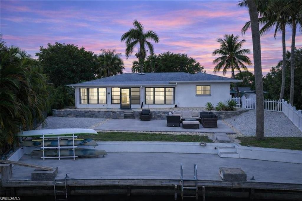3461 Lakeview Drive Naples, FL 34112 - Photo 5 of 32 a front view of a house with garden