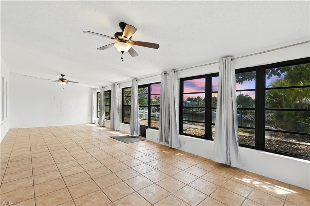 3461 Lakeview Drive Naples, FL 34112 - Photo 8 of 32 a view of an empty room with a window and a ceiling fan