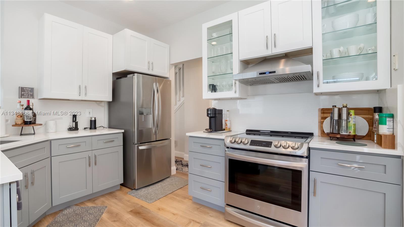 675 Falling Water Road Weston, FL 33326 - Photo 1 of 39 a kitchen with stainless steel appliances white cabinets and a stove top oven