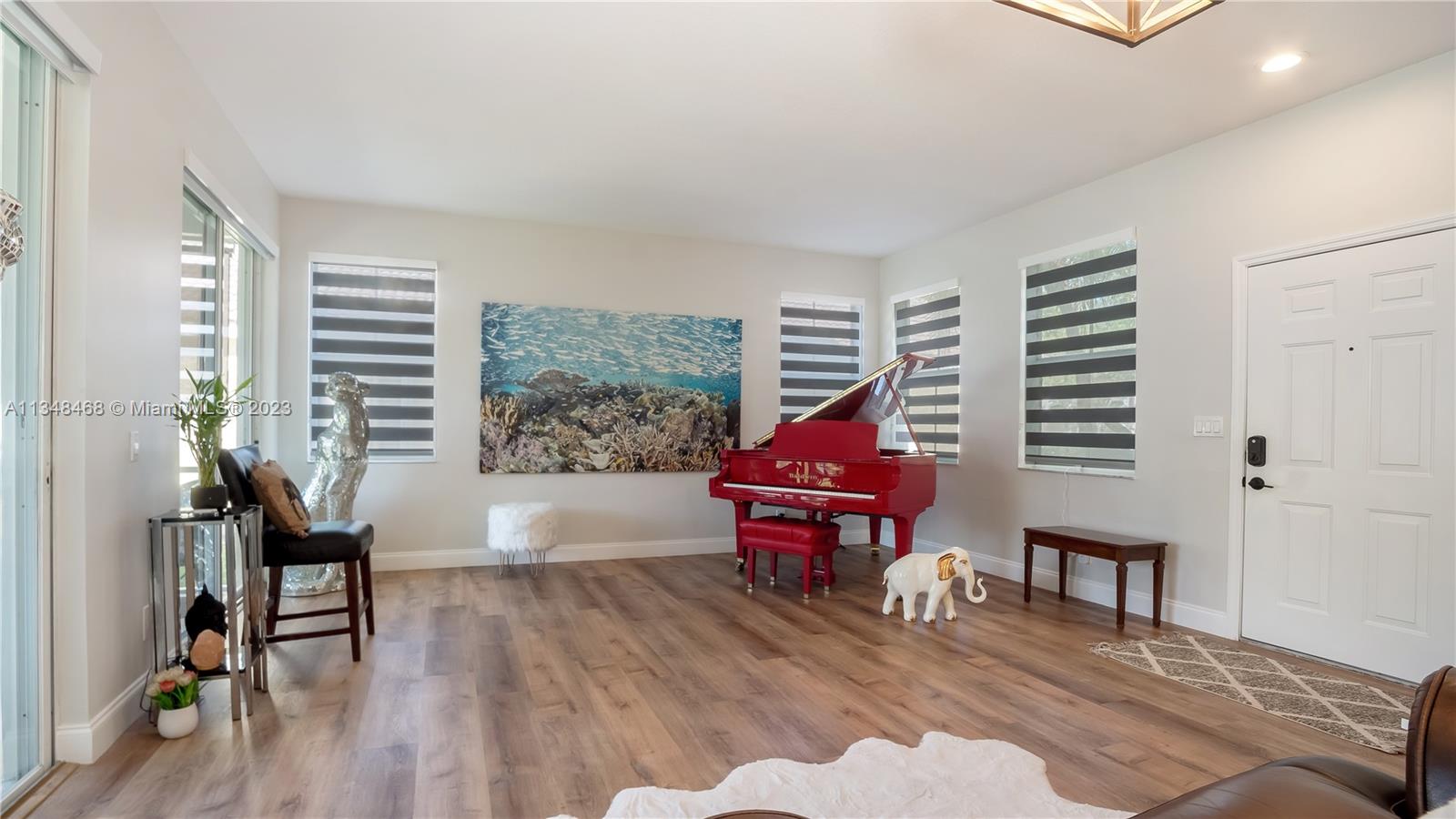 675 Falling Water Road Weston, FL 33326 - Photo 11 of 39 a living room with furniture and a wooden floor