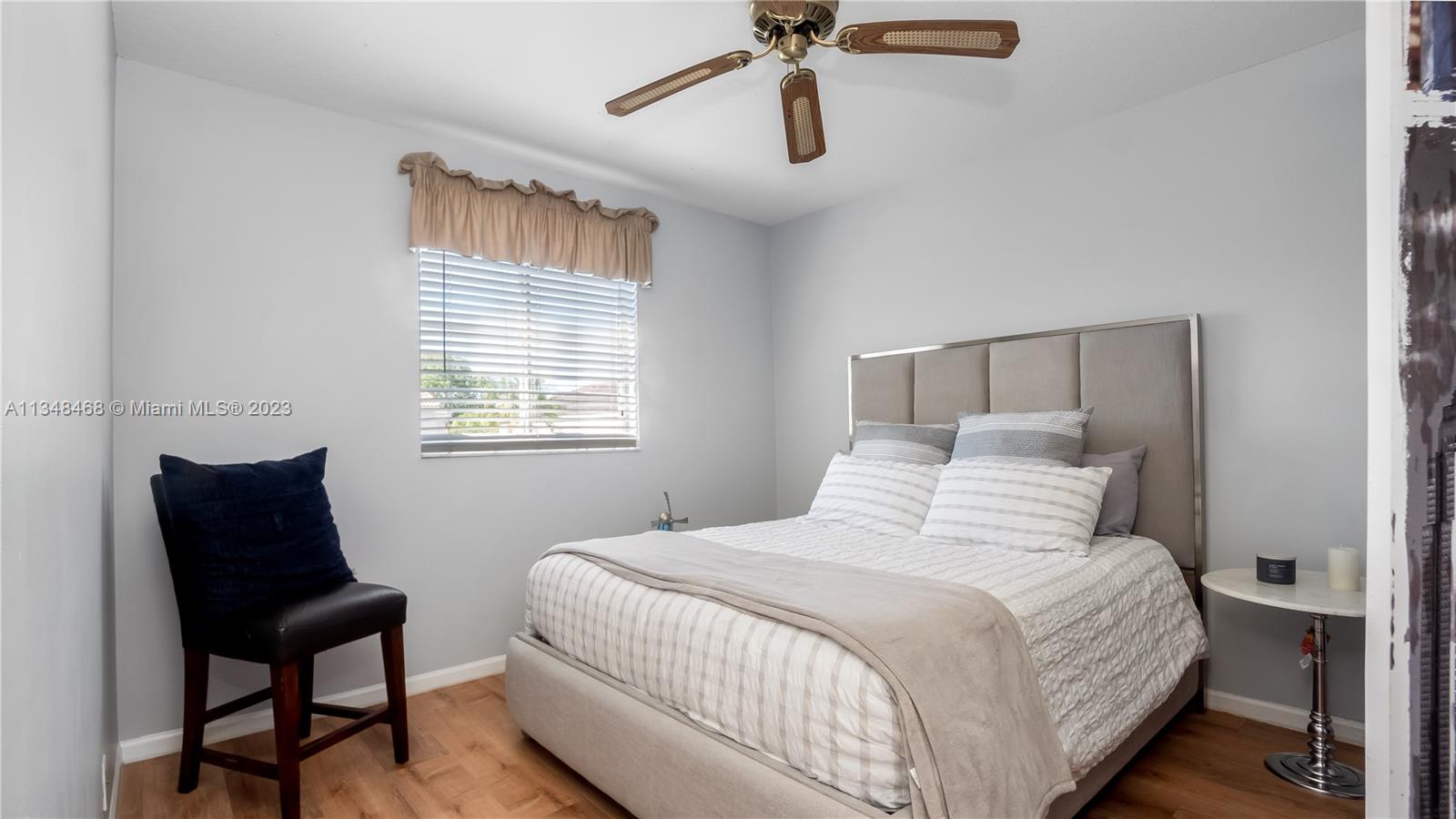 675 Falling Water Road Weston, FL 33326 - Photo 31 of 39 a bedroom with a bed and a chair