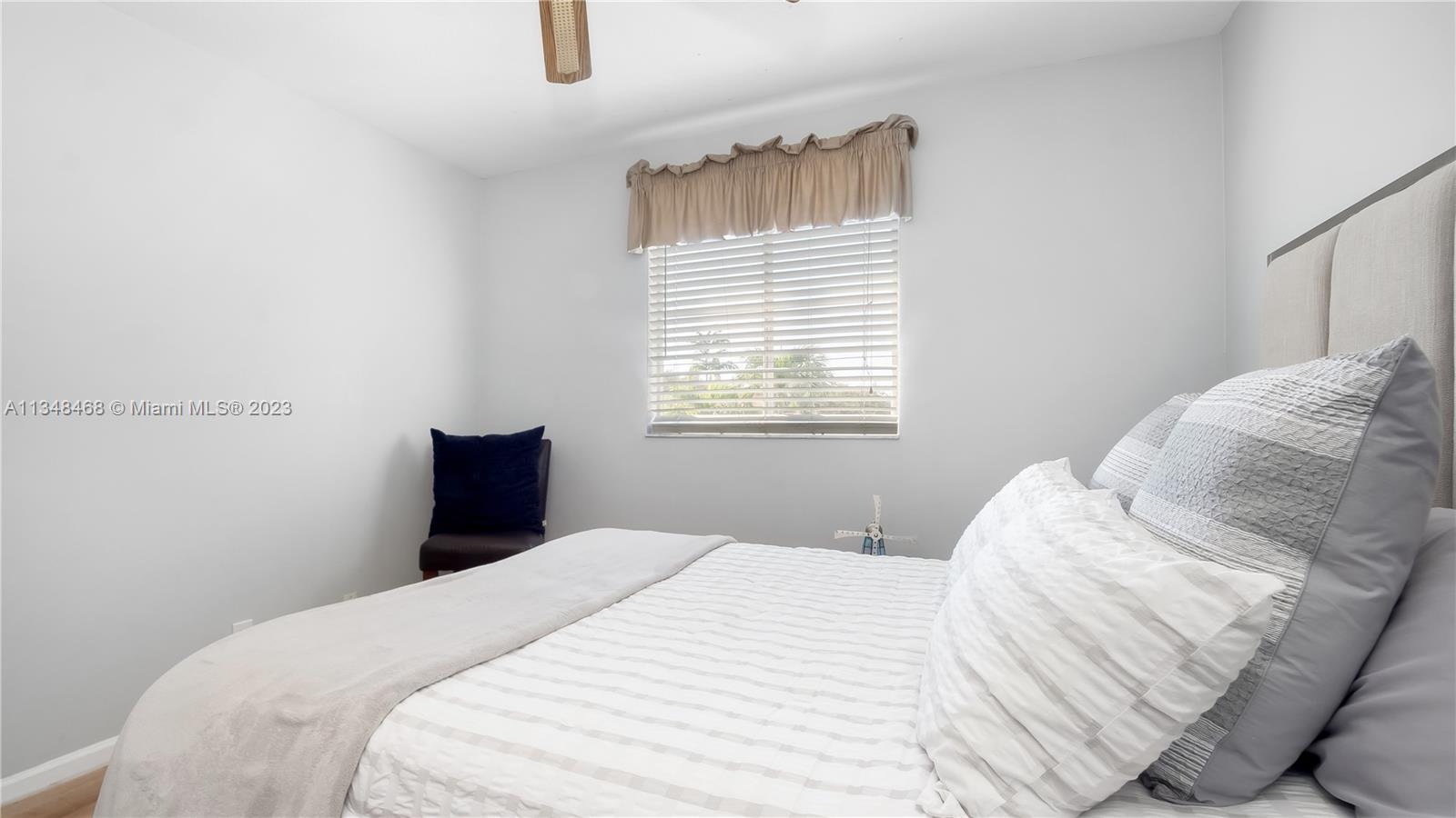 675 Falling Water Road Weston, FL 33326 - Photo 32 of 39 a bedroom with a bed and a window