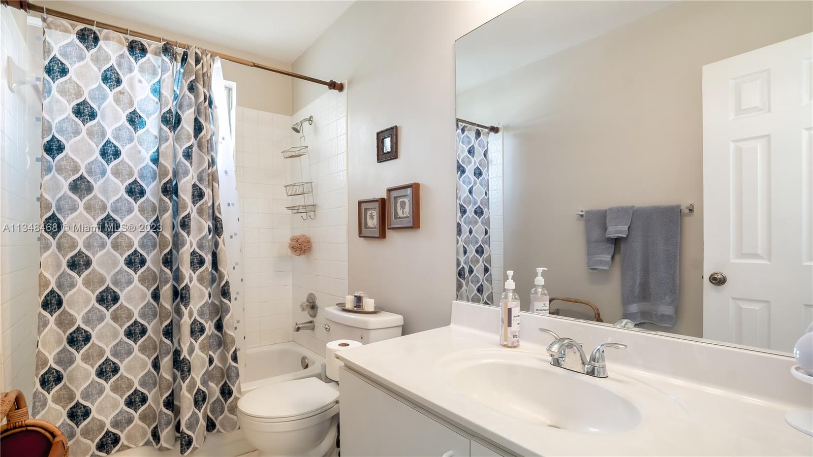 675 Falling Water Road Weston, FL 33326 - Photo 33 of 39 a bathroom with a sink and a mirror