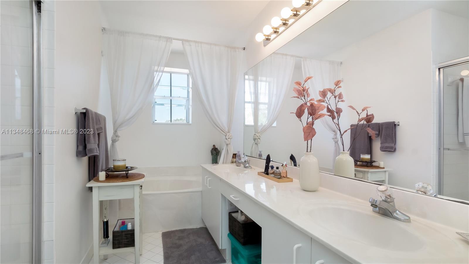 675 Falling Water Road Weston, FL 33326 - Photo 35 of 39 a bathroom with a double vanity sink a mirror and a window