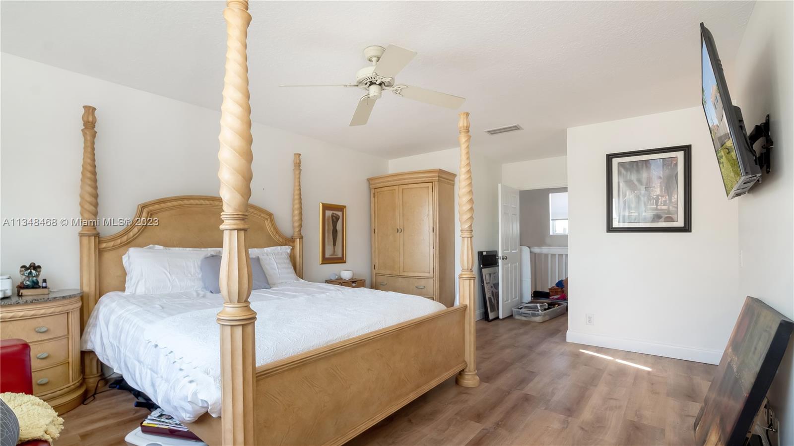 675 Falling Water Road Weston, FL 33326 - Photo 39 of 39 a bedroom with a bed large mirror and a potted plant