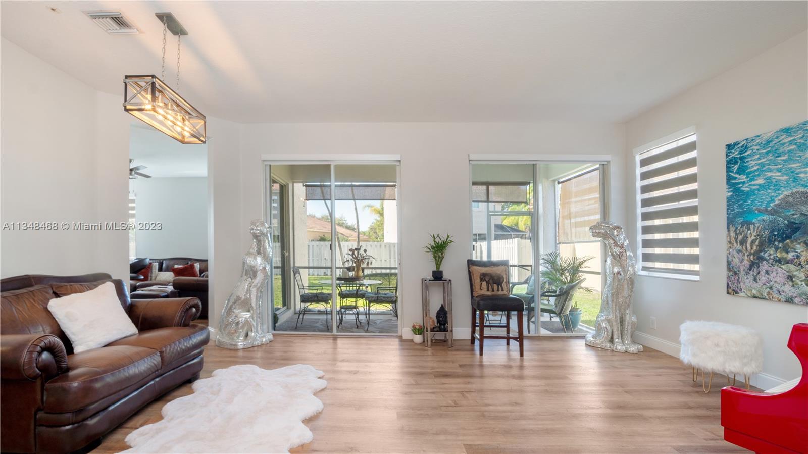 675 Falling Water Road Weston, FL 33326 - Photo 8 of 39 a living room with furniture and a wooden floor