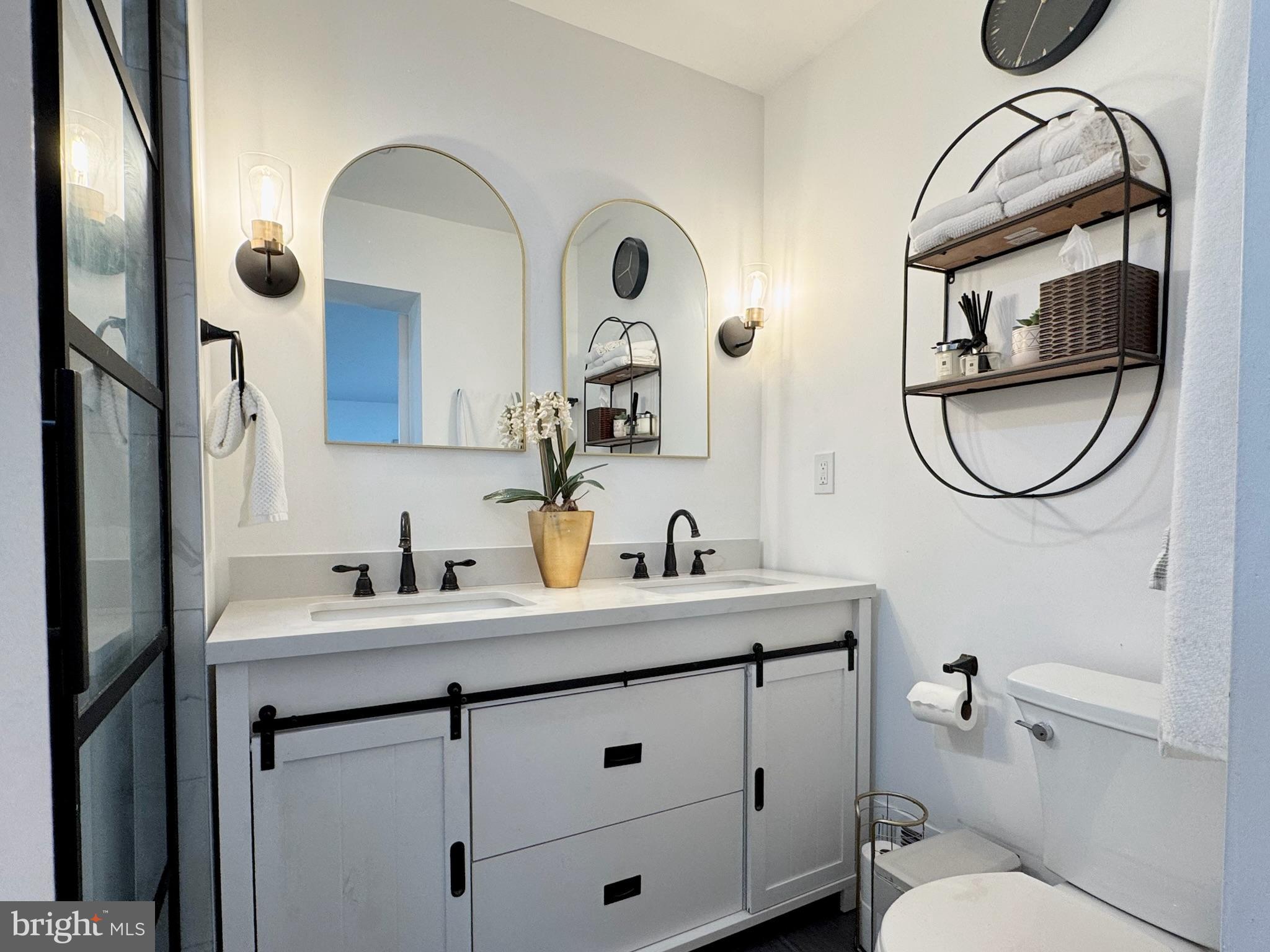 7397 New Cut Road Kingsville, MD 21087 - Photo 20 of 42 a bathroom with a toilet a sink a mirror a vanity and a shower