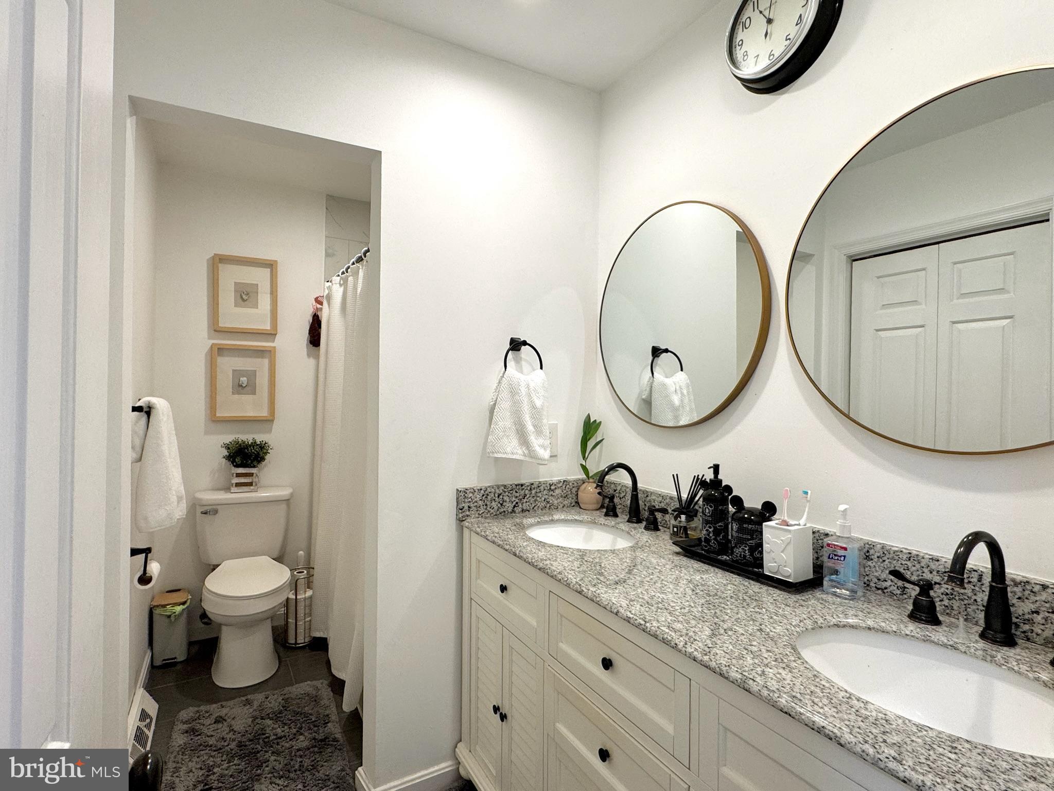 7397 New Cut Road Kingsville, MD 21087 - Photo 27 of 42 a bathroom with a granite countertop toilet a sink and a mirror