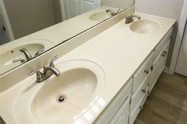 a bathroom with a tub sink and mirror
