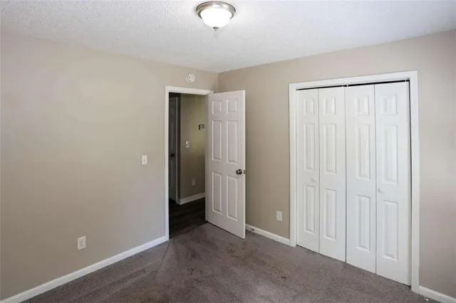 an empty room with closet area