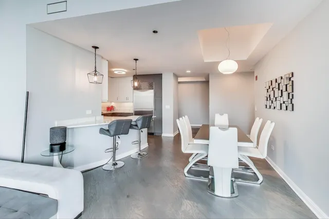 a view of a dining room with furniture and wooden floor