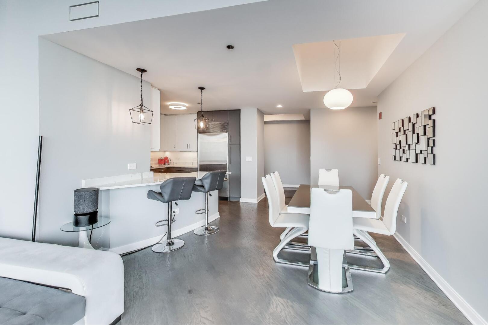 60 East Monroe Street, Unit 5103 Chicago, IL 60603 - Photo 12 of 63 a dining room with a table and chairs