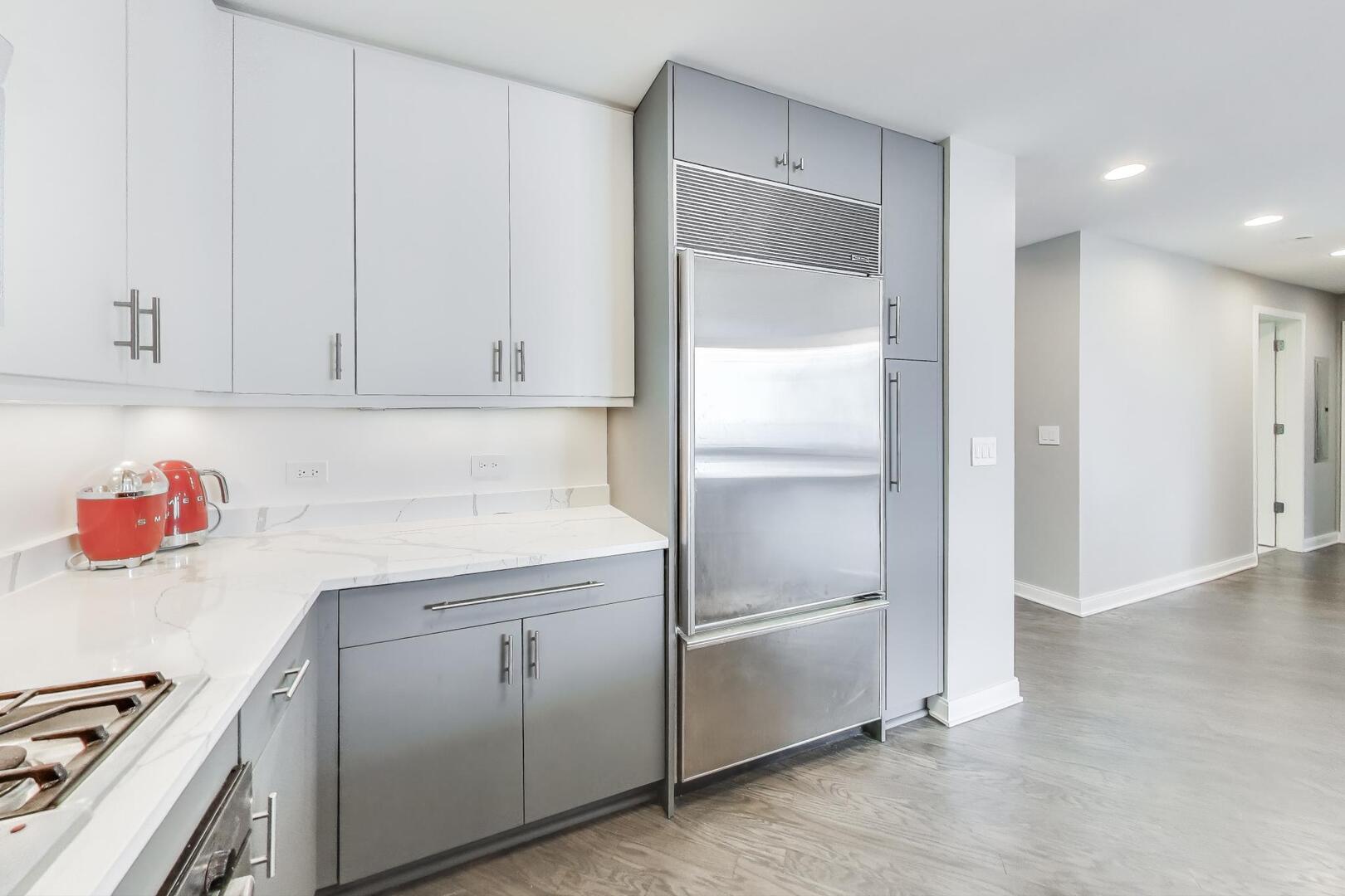 60 East Monroe Street, Unit 5103 Chicago, IL 60603 - Photo 18 of 63 a kitchen with cabinets and white appliances
