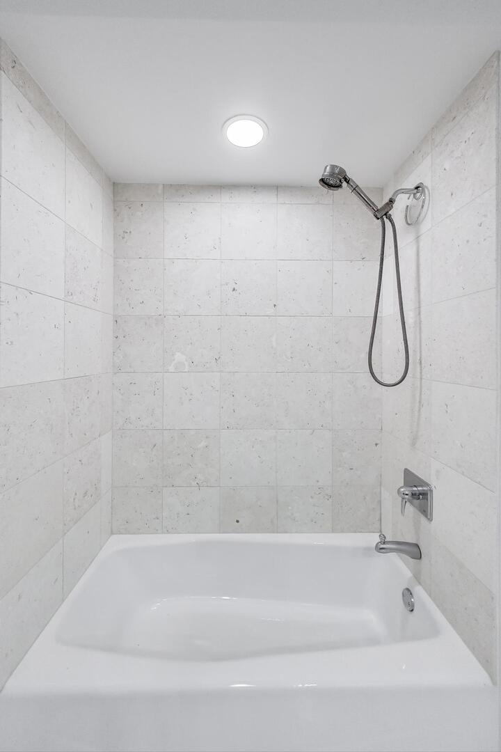 60 East Monroe Street, Unit 5103 Chicago, IL 60603 - Photo 31 of 63 a bathroom with a bath tub with a shower