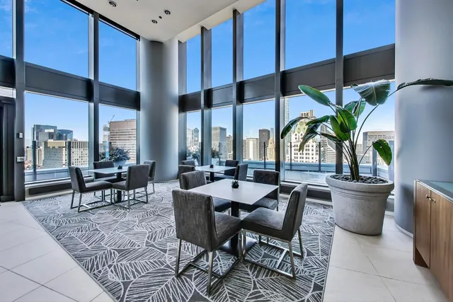 a living room with furniture and large windows