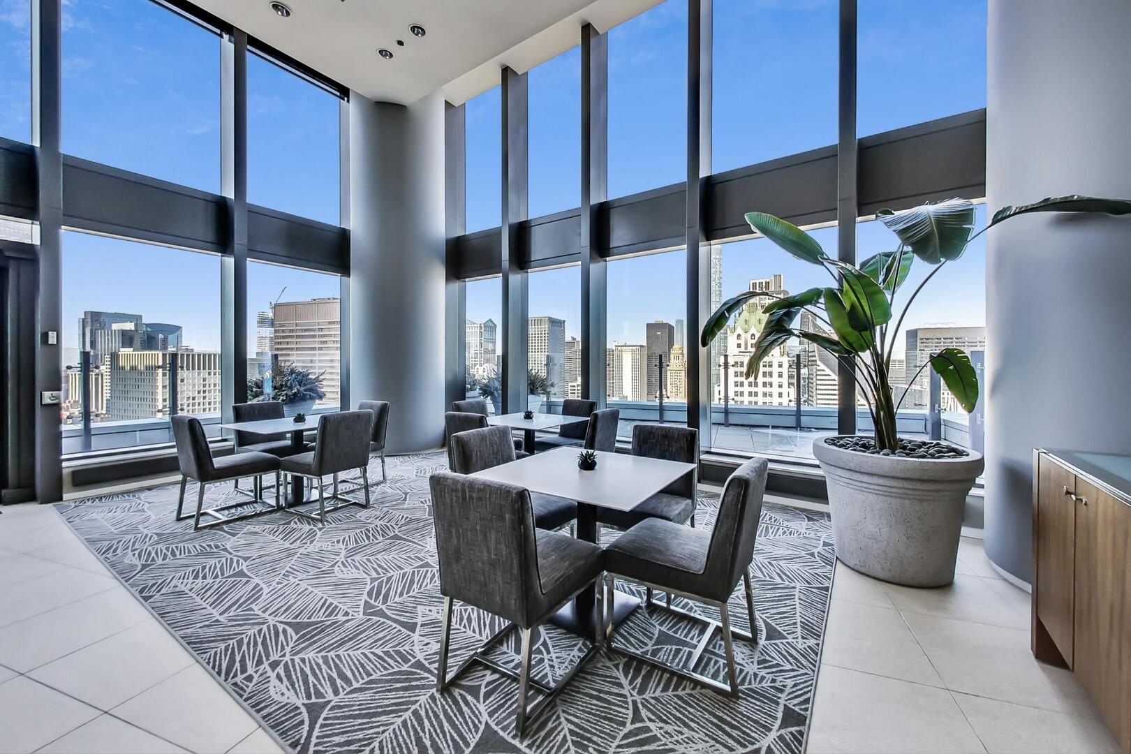 60 East Monroe Street, Unit 5103 Chicago, IL 60603 - Photo 37 of 63 a dining room with furniture a chandelier and a floor to ceiling window